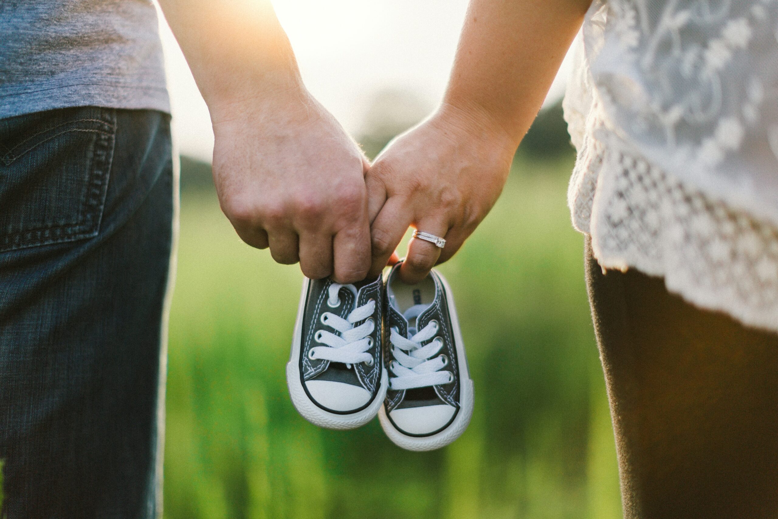https://unsplash.com/photos/woman-and-man-holding-black-crib-shoes-standing-near-green-grass-during-daytime-7tGqLzHcjZ8